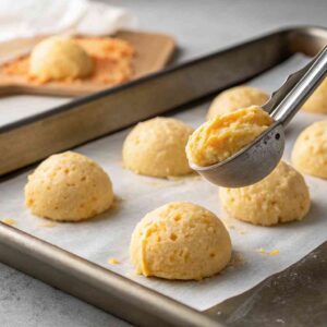 Scooping dough for cheddar mochi bread recipe