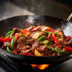 Stir-frying beef and peppers for pepper steak recipe

